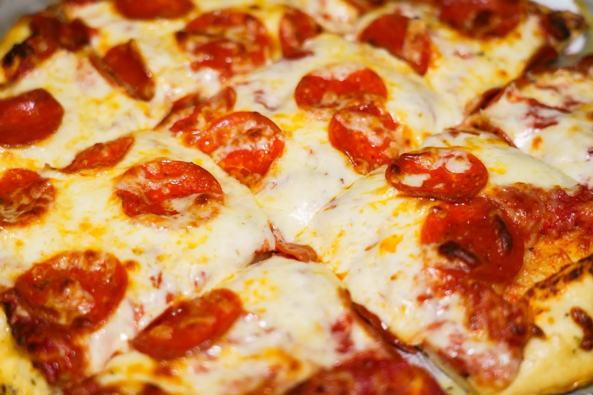 Close-up of a pepperoni pizza with bubbling melted mozzarella